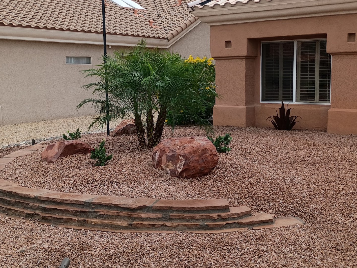 Xeriscape front yard with boulders and cactus, West Valley AZ